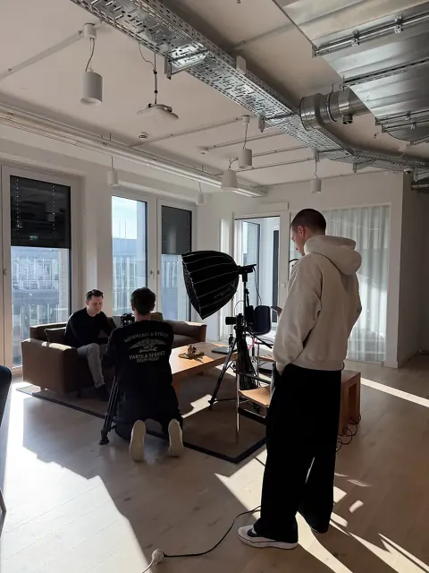 Creators and a small production crew setting up a studio interview